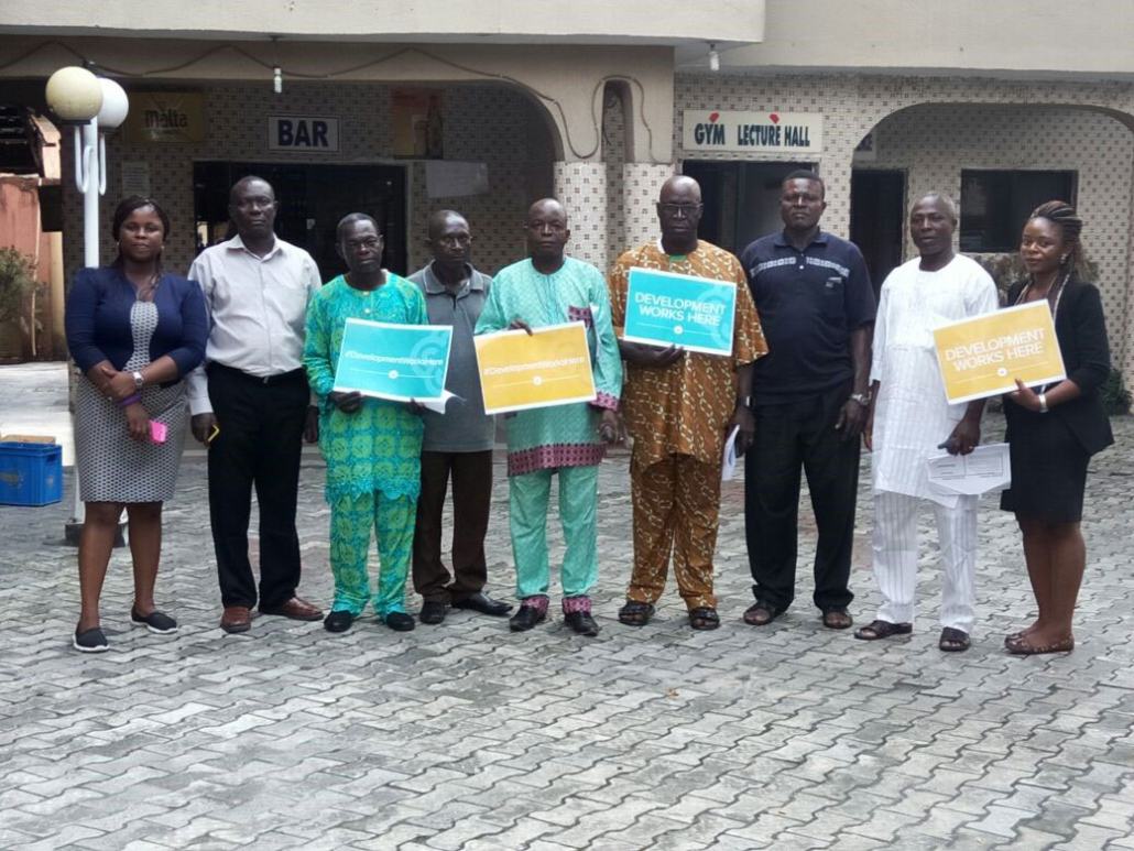 Staff of TASK and EAs holding placard to show that practical demonstration works.